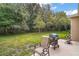 Backyard featuring patio with outdoor furniture and BBQ grill next to treeline at 3828 Arbordale Ct, Leesburg, FL 34748
