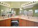 Main bathroom featuring double sinks, vanity, and framed mirrors at 3828 Arbordale Ct, Leesburg, FL 34748
