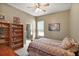 Cozy bedroom featuring a ceiling fan, closet with mirror doors, and a window at 3828 Arbordale Ct, Leesburg, FL 34748