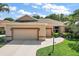 Beautiful single-story home featuring a three car garage and well maintained landscaping at 3828 Arbordale Ct, Leesburg, FL 34748