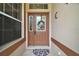 Charming front door featuring decorative wreath and sidelight window at 3828 Arbordale Ct, Leesburg, FL 34748