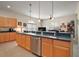 Kitchen with island, stainless steel dishwasher, and pendant lighting overlooking the living room at 3828 Arbordale Ct, Leesburg, FL 34748