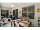 Enclosed lanai with tile flooring, ceiling fan, windows, and outdoor seating at 3828 Arbordale Ct, Leesburg, FL 34748