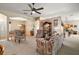 Open concept living room and dining area with bright neutral colors and floral furnishings at 3828 Arbordale Ct, Leesburg, FL 34748