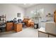 Bright office space with a wooden desk, filing cabinets, and large window providing natural light at 3828 Arbordale Ct, Leesburg, FL 34748