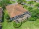 Aerial view of the back of the house showing screened in patio and manicured lawn at 383 Kilmer Way, The Villages, FL 32162