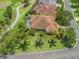 Aerial view of the back of the home showcasing a screened lanai and well-maintained yard at 383 Kilmer Way, The Villages, FL 32162