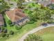 Aerial view of the back of the house featuring a screened in lanai and lush landscaping at 383 Kilmer Way, The Villages, FL 32162