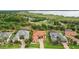 Aerial shot of upscale homes, highlighting the tile roofs, landscaping and proximity to a lake at 38716 Oak Place Ct, Lady Lake, FL 32159