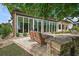 Inviting back patio with comfortable seating, a coffee table and retractable glass doors at 38716 Oak Place Ct, Lady Lake, FL 32159