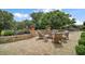 Charming backyard patio with comfortable seating, a fire pit, and lush landscaping at 38716 Oak Place Ct, Lady Lake, FL 32159