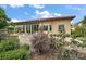 Serene backyard featuring lush landscaping, a brick patio, and an outdoor seating area at 38716 Oak Place Ct, Lady Lake, FL 32159
