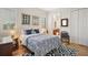 Bedroom with hardwood floors, elegant furniture, and art with view into connected bathroom at 38716 Oak Place Ct, Lady Lake, FL 32159