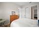 Bright bedroom with hardwood floors and view of connected bathroom through doorway at 38716 Oak Place Ct, Lady Lake, FL 32159
