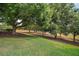 Expansive community lawn with mature trees providing ample shade, perfect for relaxation at 38716 Oak Place Ct, Lady Lake, FL 32159