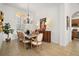 Elegant dining room featuring ample natural light and a view of the open kitchen at 38716 Oak Place Ct, Lady Lake, FL 32159