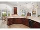 Gourmet kitchen features custom cabinetry, granite countertops, tile backsplash and stainless steel appliances at 38716 Oak Place Ct, Lady Lake, FL 32159