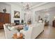 Comfortable living room featuring tile floors, a fireplace, and views into the dining area for seamless entertaining at 38716 Oak Place Ct, Lady Lake, FL 32159