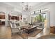 Bright living room showcasing an open layout with tile flooring, recessed lighting, and an adjacent gourmet kitchen at 38716 Oak Place Ct, Lady Lake, FL 32159