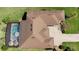Aerial view of home featuring a backyard pool, patio, and well-maintained landscaping at 39505 Hillrise Ln, Lady Lake, FL 32159