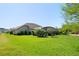 Spacious backyard features lush green grass and mature landscaping at 39505 Hillrise Ln, Lady Lake, FL 32159