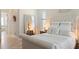 Comfortable bedroom with a large mirror, natural light, and neutral decor at 39505 Hillrise Ln, Lady Lake, FL 32159