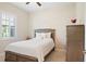 Cozy bedroom with a comfortable bed, shutters, and ample natural light at 39505 Hillrise Ln, Lady Lake, FL 32159
