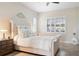 Charming bedroom with a stylish headboard, shutters, and tiled floors at 39505 Hillrise Ln, Lady Lake, FL 32159