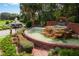 Harbor Hills community entrance with a fountain and lush landscaping at 39505 Hillrise Ln, Lady Lake, FL 32159