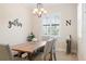 Well-lit dining room with farmhouse-style table, bench seating, and plantation shutters for a cozy, inviting atmosphere at 39505 Hillrise Ln, Lady Lake, FL 32159