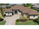 Beautifully landscaped home featuring a brick driveway, neutral tones, and a well maintained lawn at 39505 Hillrise Ln, Lady Lake, FL 32159