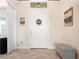 Bright foyer featuring a white door with decor, tile floors, and neutral wall tones at 39505 Hillrise Ln, Lady Lake, FL 32159