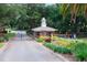 Community gatehouse surrounded by lush landscaping at 39505 Hillrise Ln, Lady Lake, FL 32159