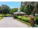 Community gatehouse surrounded by colorful landscaping at 39505 Hillrise Ln, Lady Lake, FL 32159