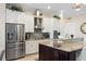 Kitchen with stainless steel appliances, granite countertops, updated cabinets, and a separate pantry for extra storage at 39505 Hillrise Ln, Lady Lake, FL 32159