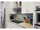 Updated kitchen showcasing stainless steel appliances, granite countertops, a stylish backsplash and ample cabinet space at 39505 Hillrise Ln, Lady Lake, FL 32159