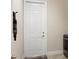 Bright laundry room featuring a white door and tile flooring at 39505 Hillrise Ln, Lady Lake, FL 32159