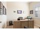 Office space featuring a wooden executive desk, plantation shutters, and tasteful decor creates a professional atmosphere at 39505 Hillrise Ln, Lady Lake, FL 32159