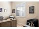 Bright office with plantation shutters, a wooden desk, and comfortable seating that offers a practical work environment at 39505 Hillrise Ln, Lady Lake, FL 32159