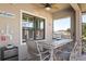 The covered patio is complete with a dining area, a mini fridge, and a ceiling fan at 39505 Hillrise Ln, Lady Lake, FL 32159