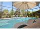 Relax in the pool with a tanning ledge or on the surrounding patio with lush tropical landscaping at 39505 Hillrise Ln, Lady Lake, FL 32159