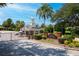 Harbor Hills West Gate entrance featuring brick pillars, landscaping, and a guard house with a cupola at 39505 Hillrise Ln, Lady Lake, FL 32159