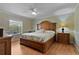 Spacious bedroom with wood floors, ceiling fan, and natural light from the window at 411 Loma Paseo Dr, The Villages, FL 32159