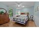 Cozy bedroom featuring smooth walls, ceiling fan, laminate floor and decorative quilt at 411 Loma Paseo Dr, The Villages, FL 32159