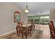 Bright dining area with wood table and access to the kitchen and sunroom, creating an inviting space at 411 Loma Paseo Dr, The Villages, FL 32159