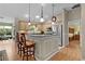 Open kitchen featuring pendant lighting, stainless appliances and eat-in counter seating at 411 Loma Paseo Dr, The Villages, FL 32159