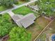 Aerial view of a cozy home with a large backyard and fence, surrounded by lush greenery at 4145 Dora Wood Dr, Mount Dora, FL 32757