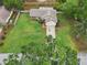 Aerial view of a home with a large, well-maintained lawn, a long driveway, and mature trees at 4145 Dora Wood Dr, Mount Dora, FL 32757
