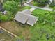 Aerial view of a single Gathering home, highlighting the roof, backyard, and wooded lot at 4145 Dora Wood Dr, Mount Dora, FL 32757