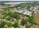 Aerial view of a neighborhood with lush greenery, including homes and commercial business storage units on a lake at 4145 Dora Wood Dr, Mount Dora, FL 32757